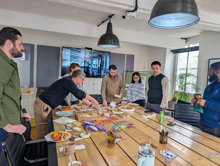 The Morrison Design team gathered around a table in the conference room of their studio, tucking into some fuddle food.