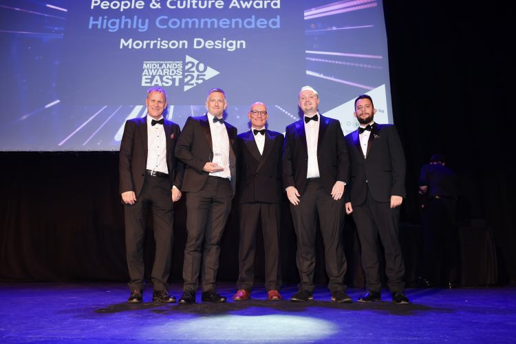 Dale Roberts, David Gardner, Michael Clarke and Sunny Kochchat collecting the highly commended award. They’re on stage and dressed in black tie.