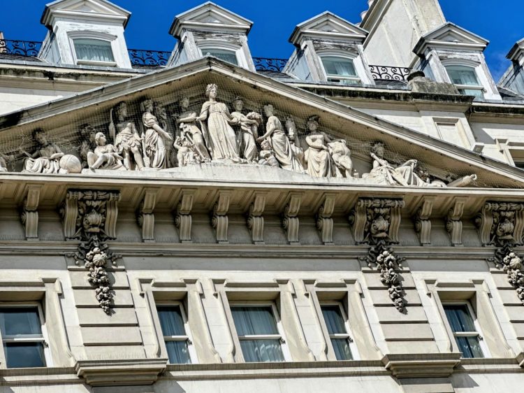 External view of the top of the Hilton Paddington – the area shown is a zoomed in view of ornate stone carvings high above the main entrance.