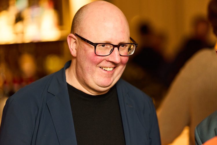 Peter Newman-Earp at the event, smiling and looking away from camera