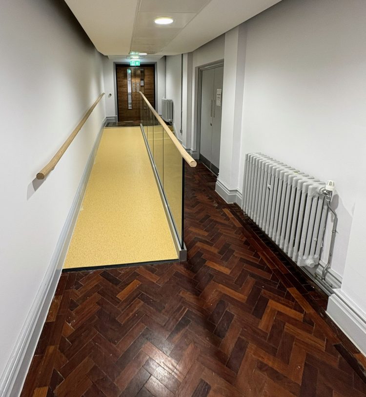 Corridor with original parquet floor and accessibility ramp