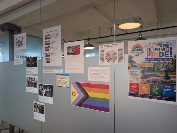 The Pride kitchen display - a glass partition wall with informative posters.